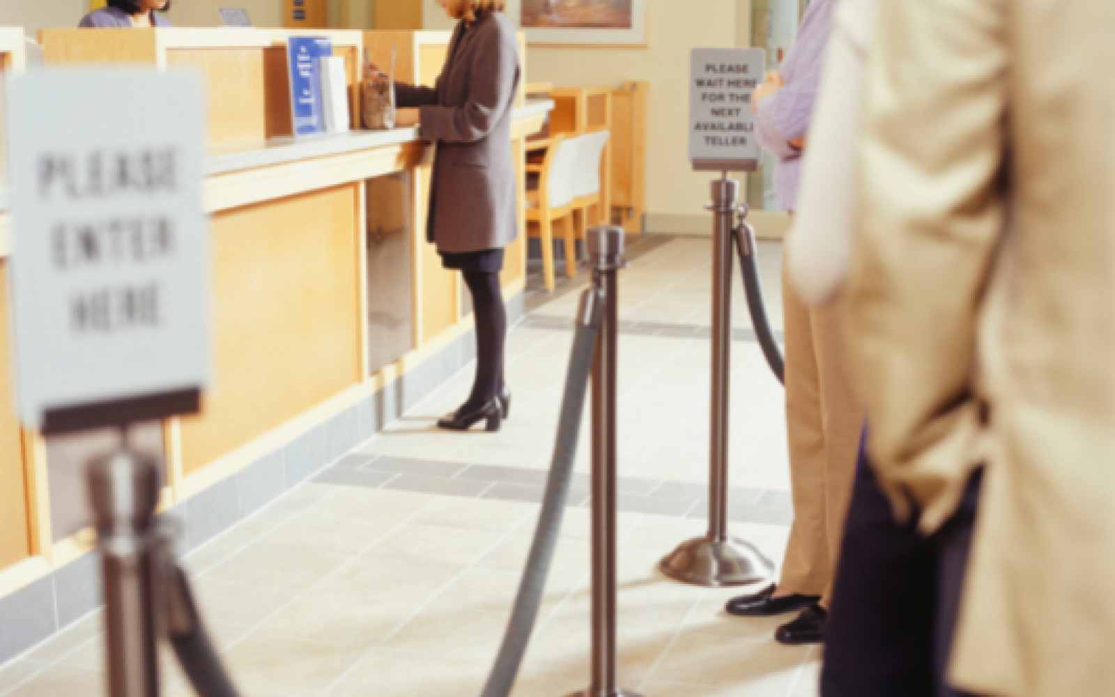 Customers standing in a long queue at a big bank before contacting a local mortgage lender.