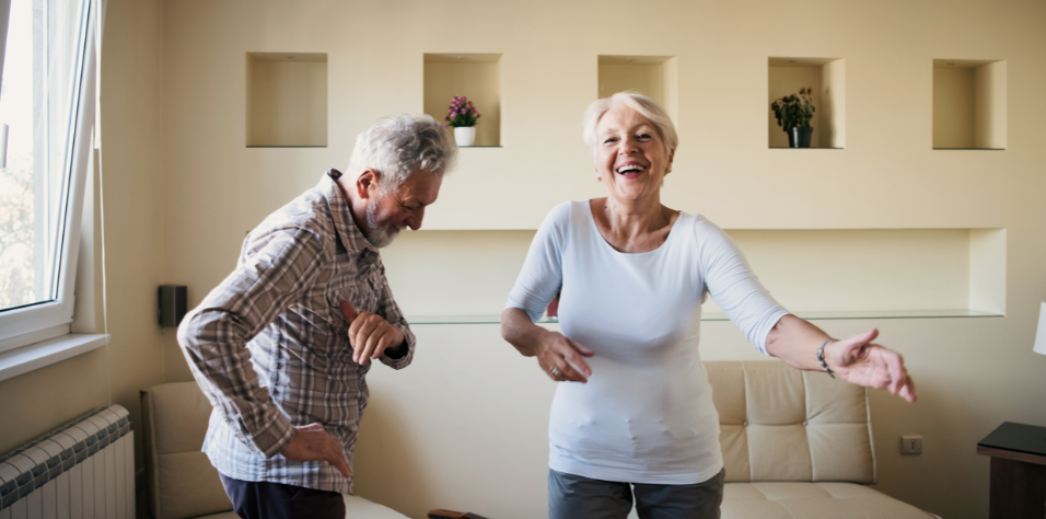 Retired couple dancing and happy with tax free equity from reverse mortgage.