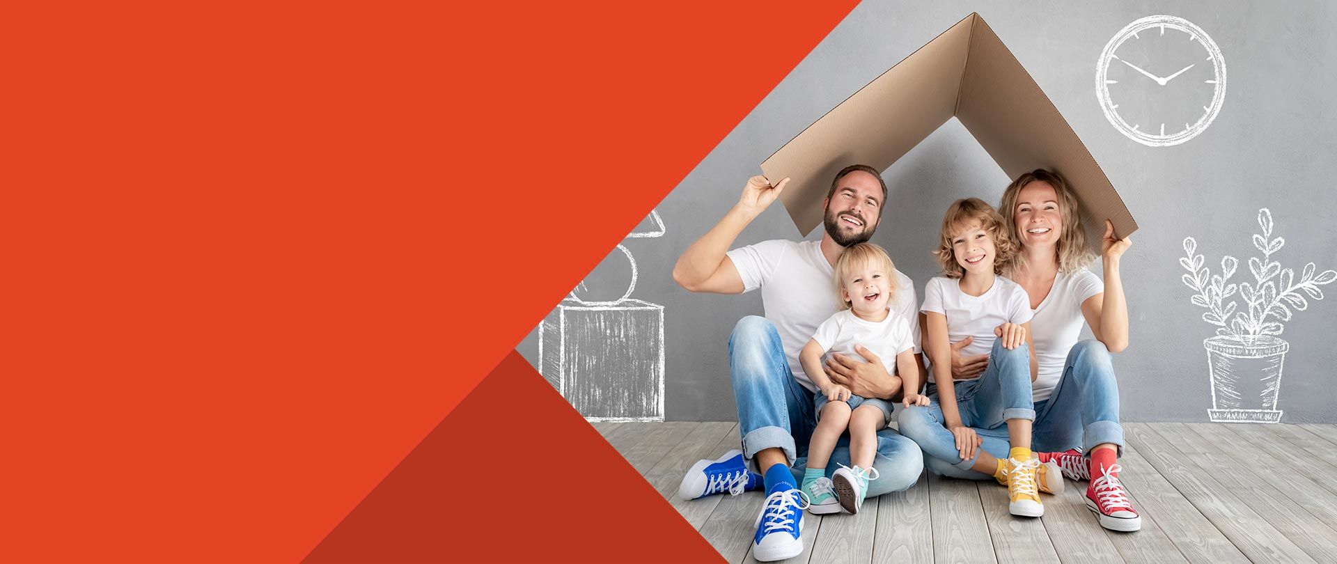 Family sitting on floor with moving box in new home through mortgage lender.