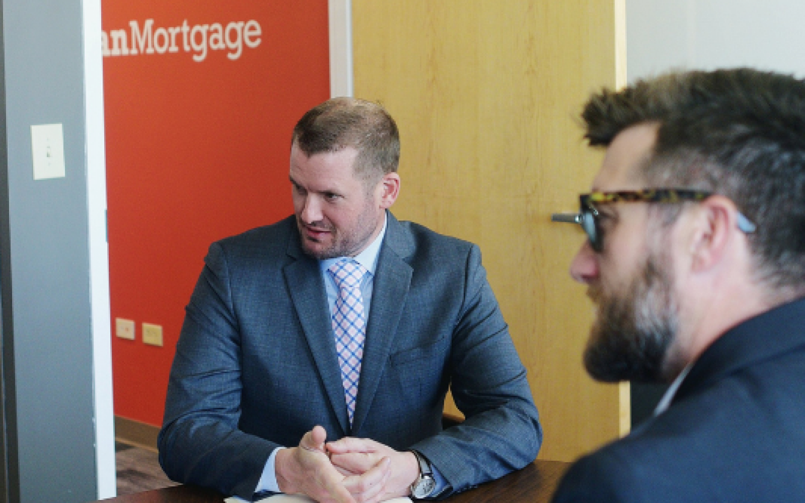 Mortgage lenders Nathan Beauchamp and Nathan Jennison sitting side by side during a consultation.