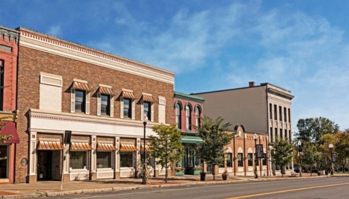 Building on historic main street, trees in the foreground.