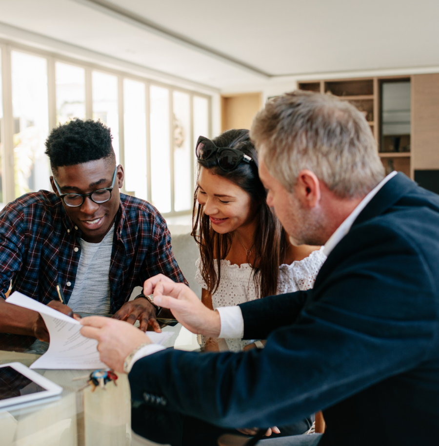 Realtor and couple closing on home contract with a cash offer loan.